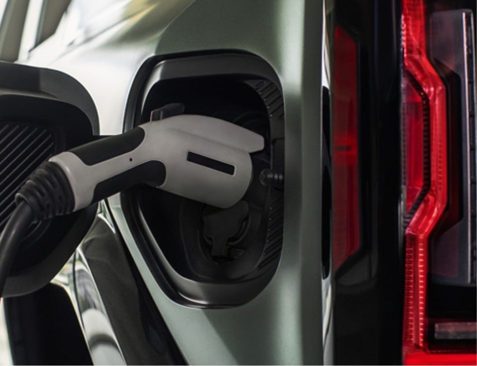 Close up of charging port with charger plugged in on a GMC Hummer EV SUV - Wolf Chevrolet GMC of Ogallala in ogallala NE